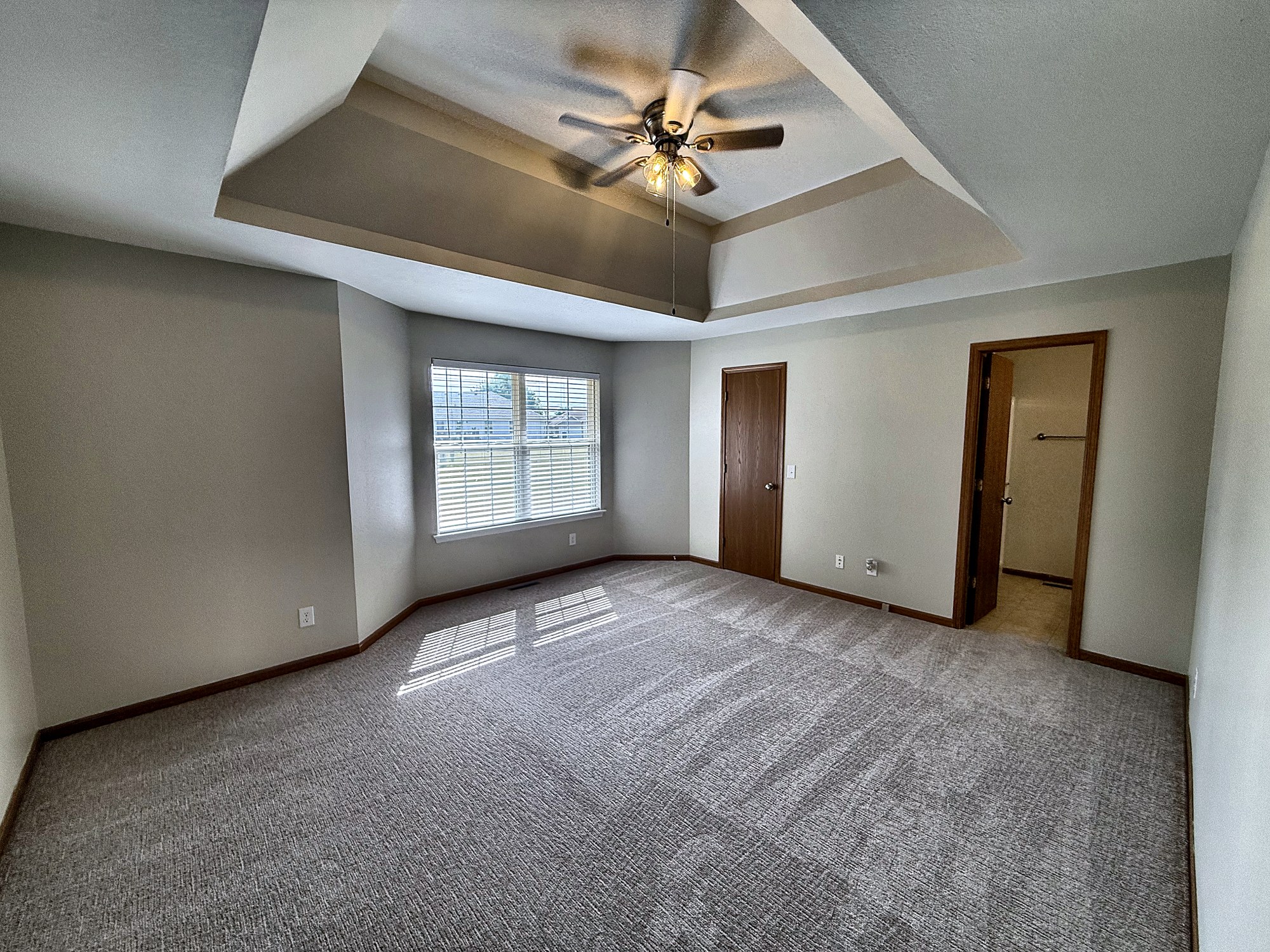 Primary bedroom with tray ceiling